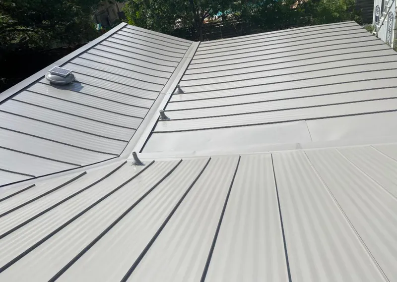Solar attic fan installed on a metal roof for Roof Ventilation in Live Oak